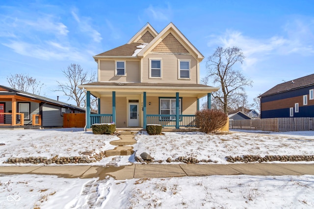 view of front of home with covered porch and fence