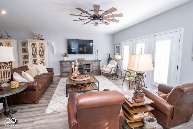 living room featuring ceiling fan and light hardwood / wood-style floors