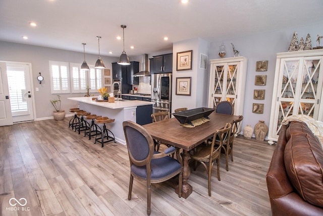 dining area featuring light wood-type flooring