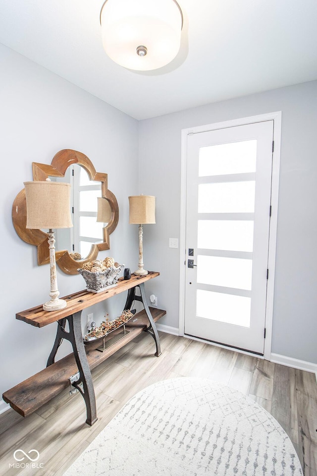 foyer entrance with light hardwood / wood-style floors