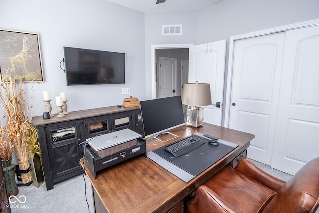 carpeted office featuring ceiling fan