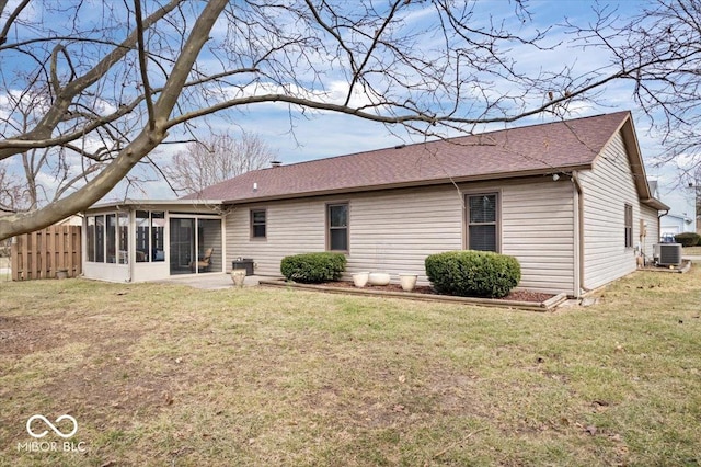 rear view of property with a yard, a sunroom, and central air condition unit