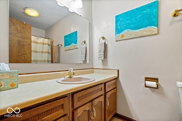 full bathroom with toilet, a shower with shower curtain, a textured ceiling, and vanity