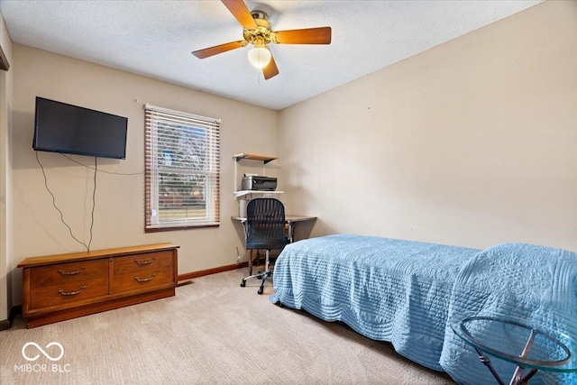 bedroom featuring light carpet, ceiling fan, baseboards, and a textured ceiling