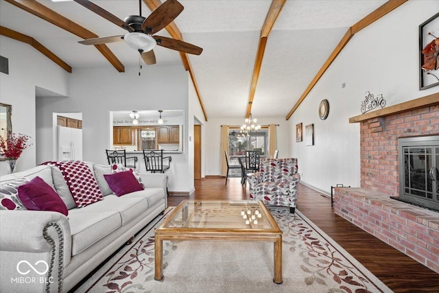 living area featuring dark wood-style floors, beam ceiling, a fireplace, high vaulted ceiling, and ceiling fan with notable chandelier