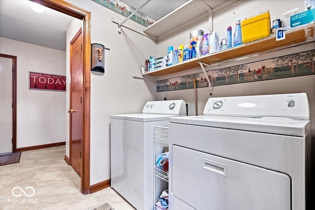 clothes washing area featuring laundry area, baseboards, and separate washer and dryer