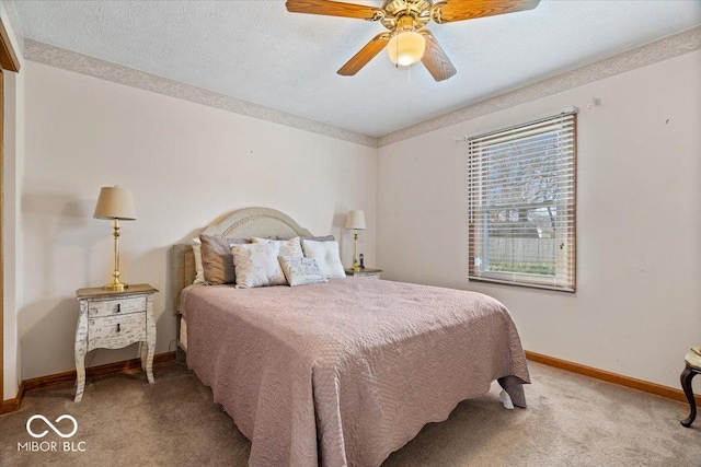 carpeted bedroom featuring a textured ceiling, a ceiling fan, and baseboards