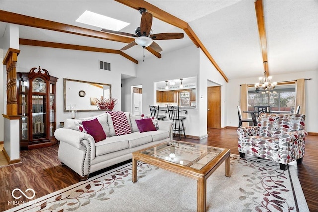 living area featuring a skylight, beam ceiling, visible vents, wood finished floors, and baseboards