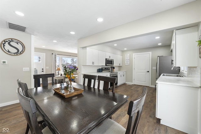 dining space featuring sink and dark hardwood / wood-style floors