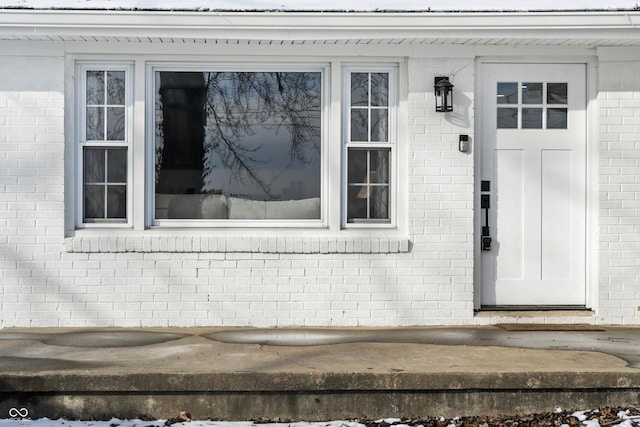 view of snow covered property entrance