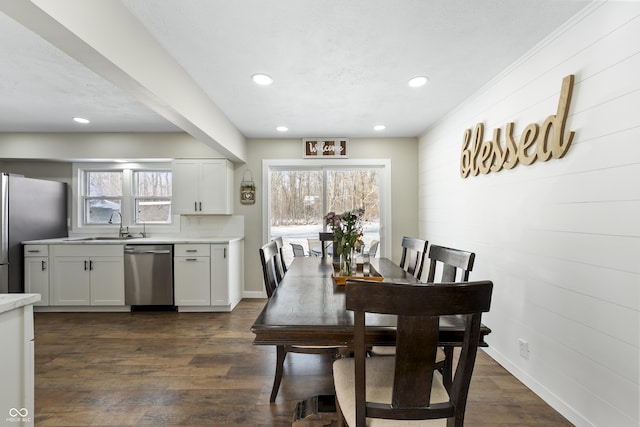 dining space with sink, dark wood-type flooring, and a wealth of natural light