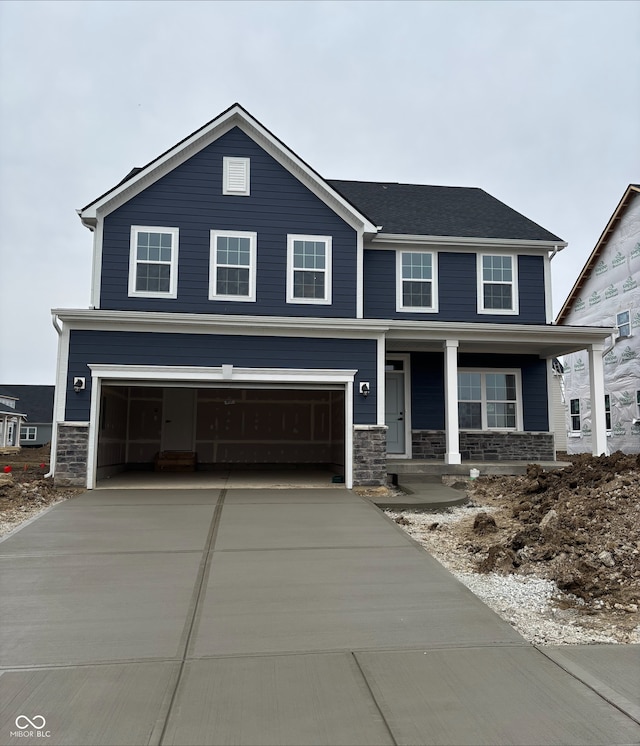 view of front facade with a garage and covered porch