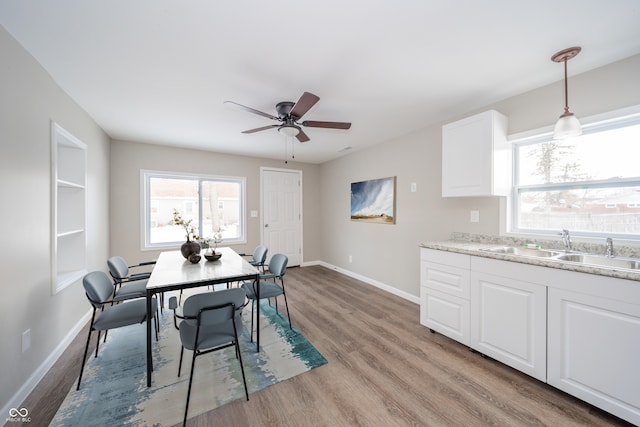 227 W 7th St, Lapel, IN 46051 - dining area with light wood-style flooring, baseboards, and ceiling fan