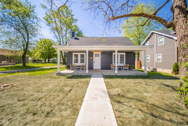 227 W 7th St, Lapel, IN 46051 - view of front of property with a front yard, a chimney, roof with shingles, and central AC unit