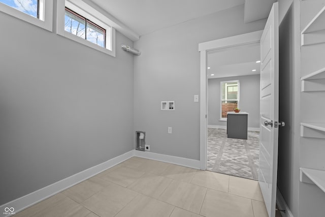 clothes washing area with light tile patterned floors, plenty of natural light, hookup for a washing machine, and electric dryer hookup