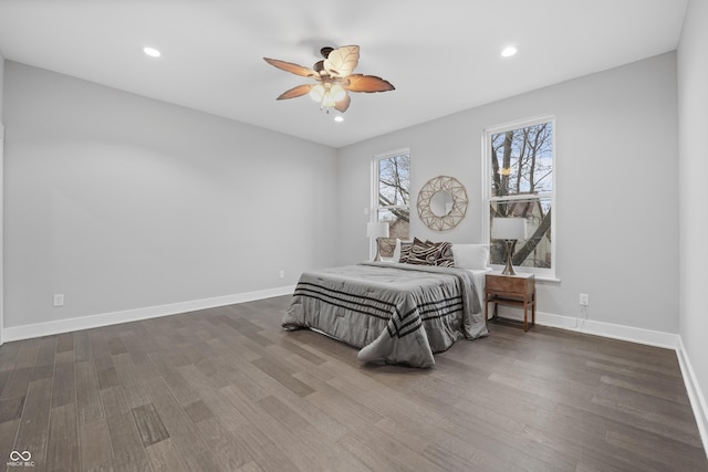 bedroom with dark hardwood / wood-style floors and ceiling fan