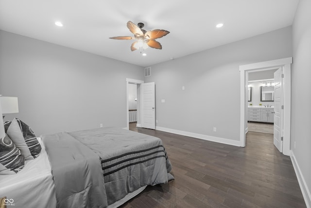 bedroom featuring ceiling fan, connected bathroom, dark hardwood / wood-style flooring, and sink