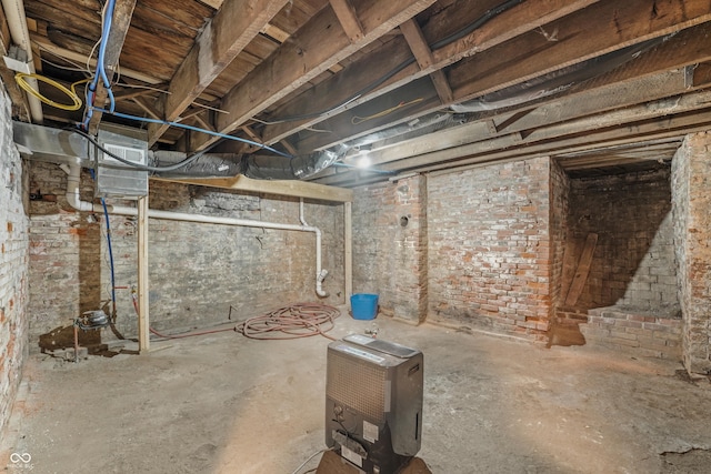 basement with brick wall