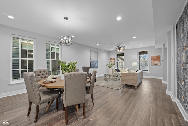 dining room with a notable chandelier and dark hardwood / wood-style flooring