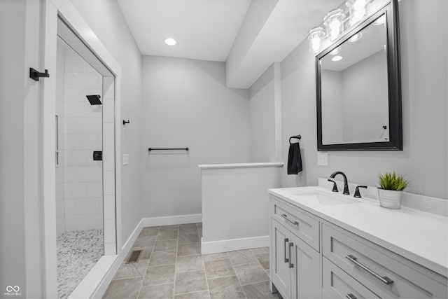 bathroom with vanity and tiled shower