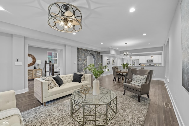 living room featuring an inviting chandelier and hardwood / wood-style floors