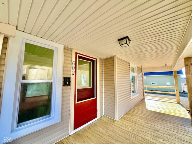 wooden terrace featuring covered porch