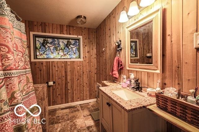 bathroom with vanity and wood walls