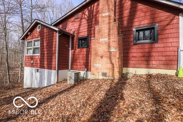 view of side of property with central AC