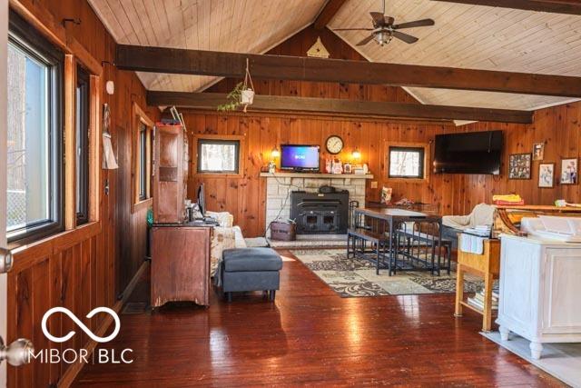 living room with hardwood / wood-style floors and wood walls