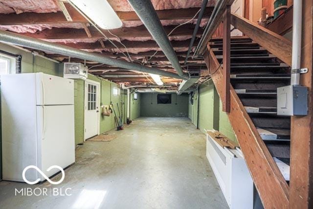 basement with white refrigerator