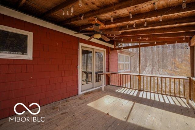 wooden terrace featuring ceiling fan