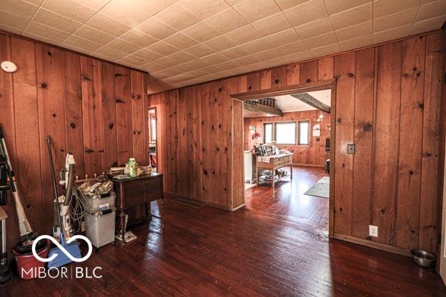 interior space featuring dark hardwood / wood-style flooring and wood walls