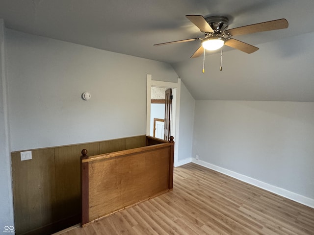 additional living space featuring ceiling fan, lofted ceiling, and light wood-type flooring