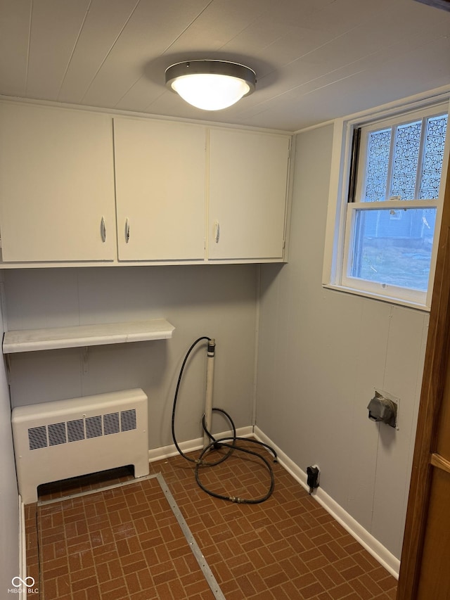 washroom featuring cabinets, radiator, and hookup for a washing machine