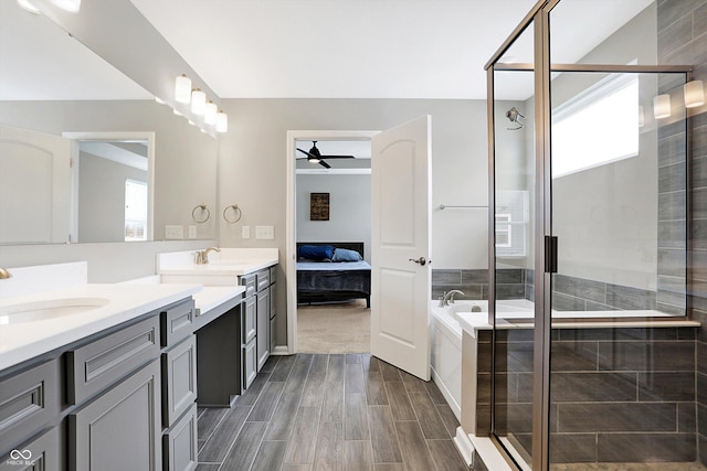 ensuite bathroom featuring a healthy amount of sunlight, a ceiling fan, and a shower stall