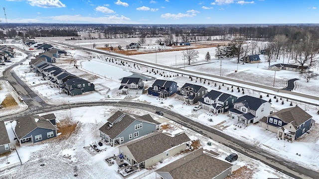snowy aerial view featuring a residential view
