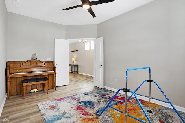 playroom featuring baseboards, a ceiling fan, wood finished floors, and visible vents