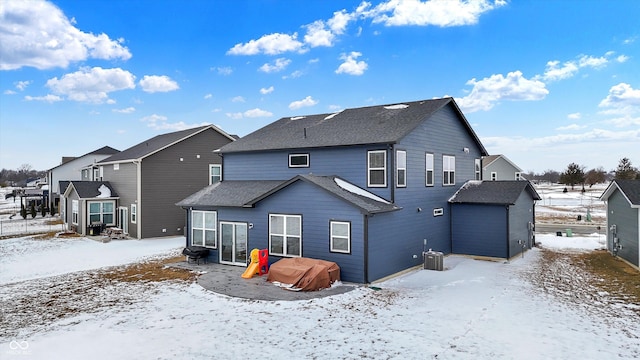 view of snow covered back of property