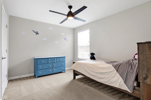 bedroom featuring baseboards, ceiling fan, and light carpet
