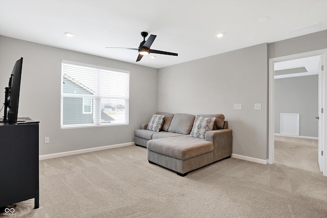 living room with light colored carpet, recessed lighting, baseboards, and ceiling fan