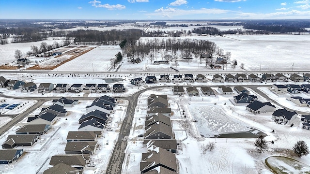 snowy aerial view with a residential view