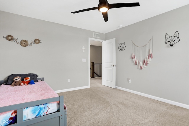 carpeted bedroom featuring baseboards, ceiling fan, and visible vents
