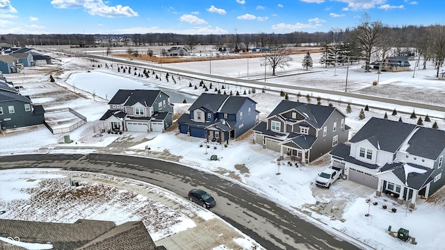 snowy aerial view with a residential view