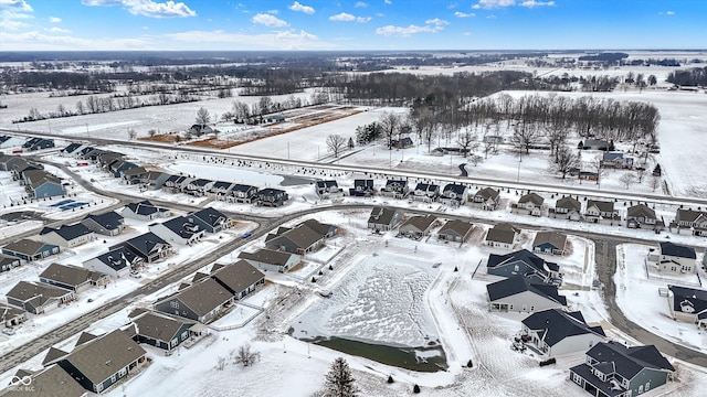 snowy aerial view featuring a residential view