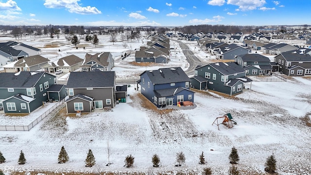 snowy aerial view with a residential view