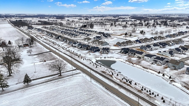 snowy aerial view with a residential view