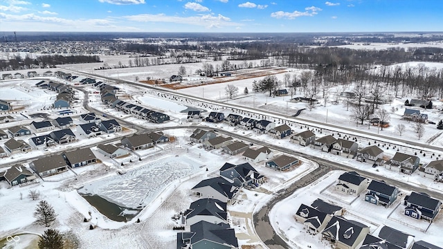snowy aerial view featuring a residential view