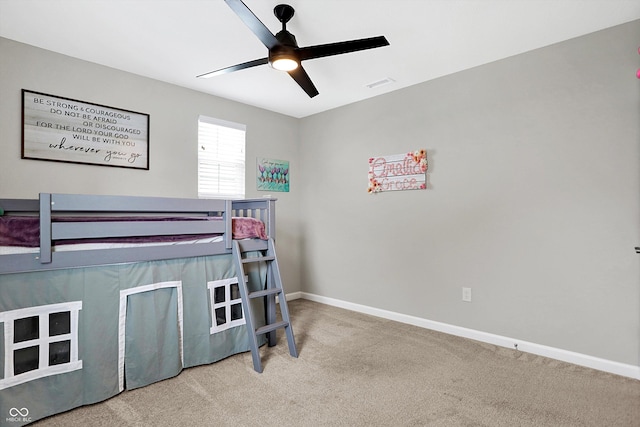 carpeted bedroom featuring baseboards, ceiling fan, and visible vents