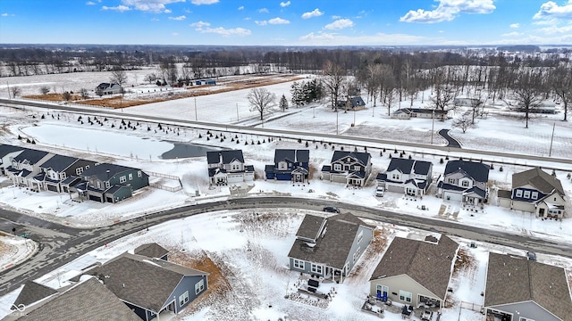 snowy aerial view featuring a residential view