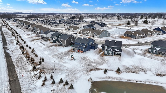 snowy aerial view with a residential view